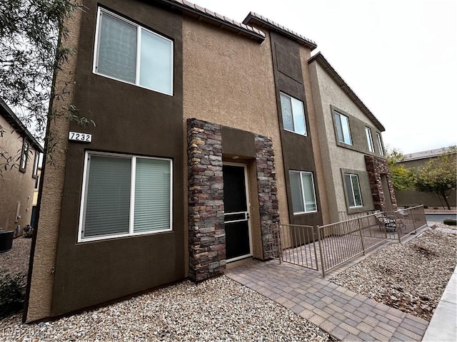 7232 Halo Falls St, North Las Vegas, NV 89084 - view of front of home with stucco siding, a patio, and stone siding