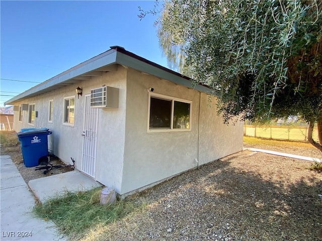 view of home's exterior featuring a wall mounted AC