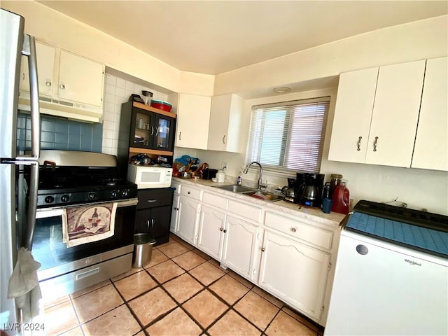 kitchen featuring decorative backsplash, stainless steel appliances, exhaust hood, sink, and white cabinetry