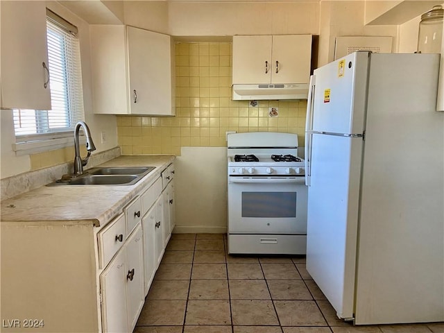 kitchen featuring white cabinets, white appliances, sink, and light tile patterned floors