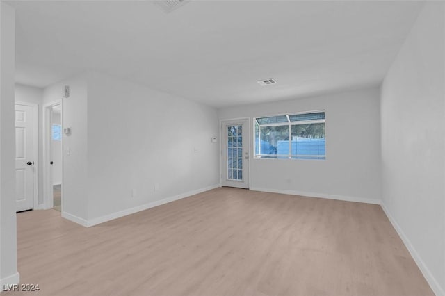 empty room with light hardwood / wood-style flooring