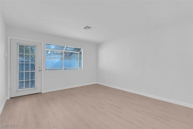 unfurnished room with light hardwood / wood-style flooring