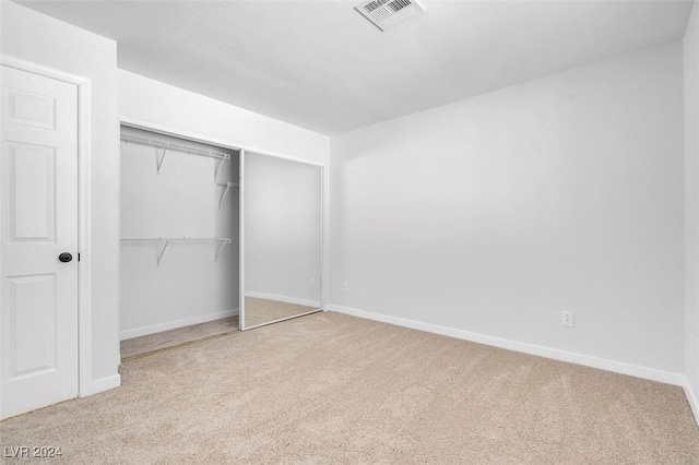 unfurnished bedroom with carpet flooring and a closet