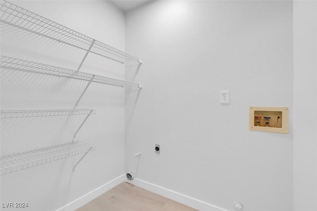 washroom featuring washer hookup, wood-type flooring, and hookup for an electric dryer