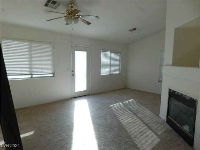 unfurnished living room with ceiling fan and light colored carpet