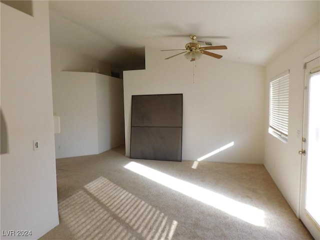 empty room featuring ceiling fan and light colored carpet