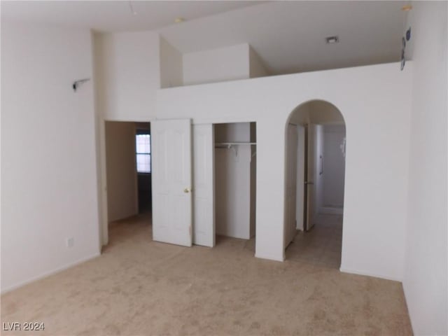 unfurnished bedroom featuring light carpet