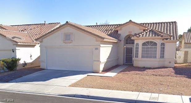 mediterranean / spanish-style house featuring a garage