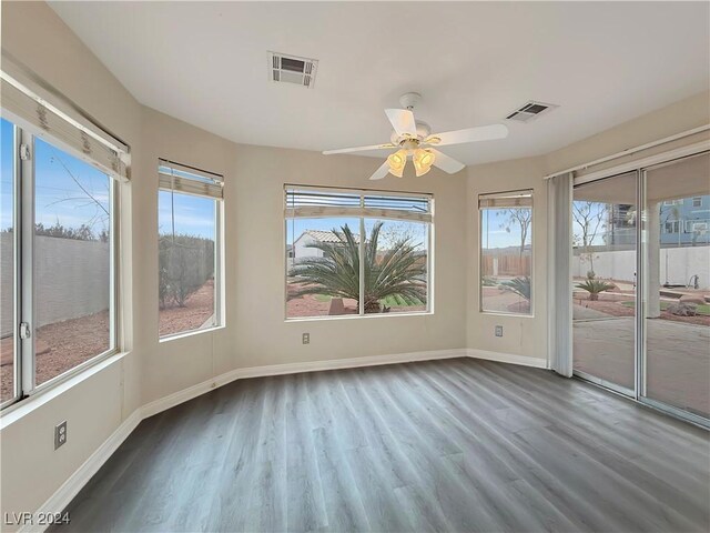 unfurnished sunroom featuring visible vents and a ceiling fan