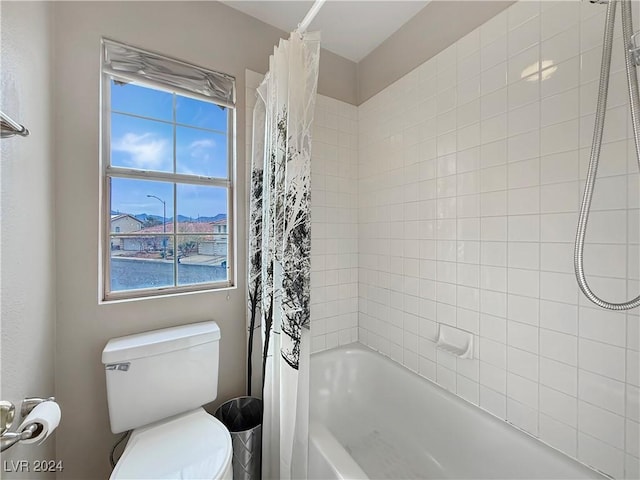 full bathroom with toilet and shower / tub combo with curtain