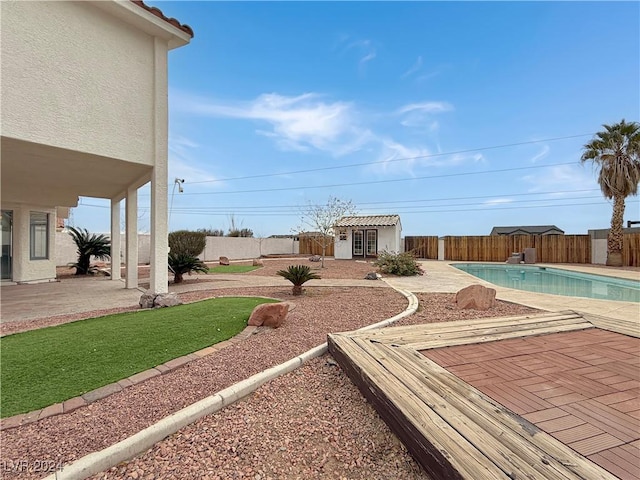 view of yard featuring a fenced in pool, a fenced backyard, and a patio