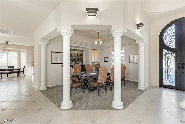 tiled dining space with french doors and a chandelier