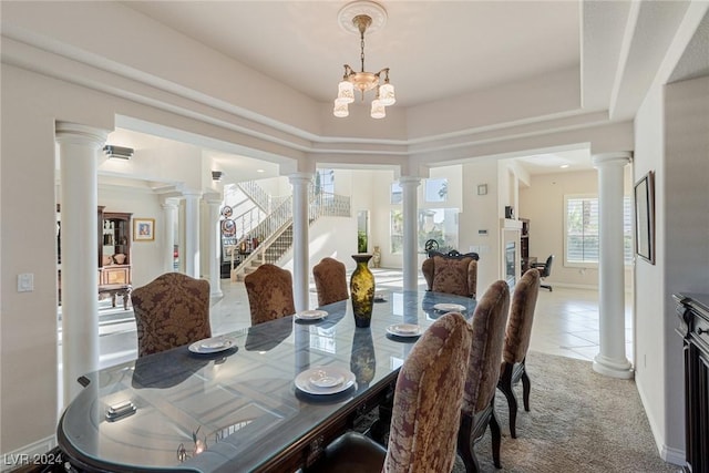 carpeted dining space featuring a tray ceiling and a notable chandelier