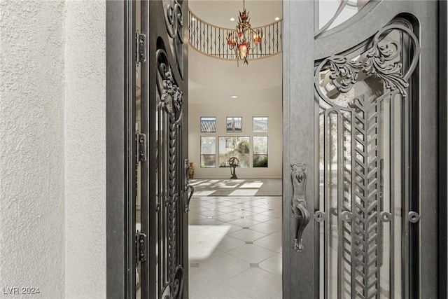 entryway with tile patterned floors and a notable chandelier