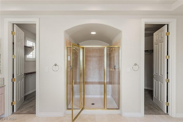 bathroom with tile patterned flooring, vanity, and an enclosed shower