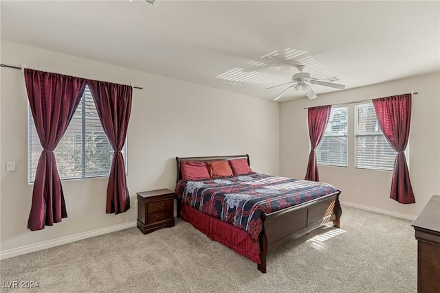 bedroom with ceiling fan and light colored carpet