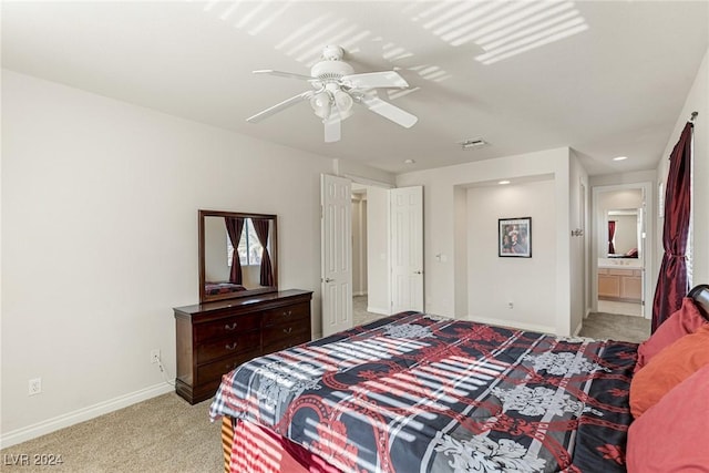 bedroom featuring ensuite bath, ceiling fan, and light colored carpet