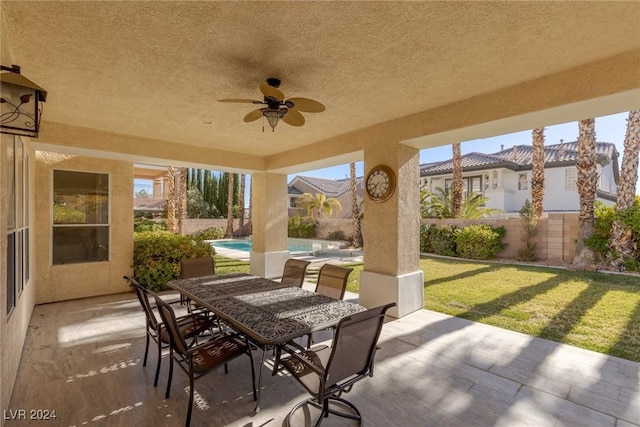 view of patio / terrace with a fenced in pool and ceiling fan