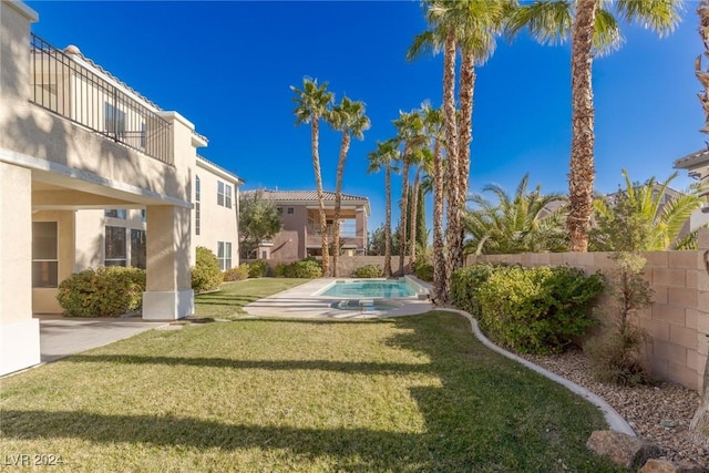 view of yard featuring a patio, a balcony, and a fenced in pool