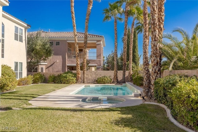 view of swimming pool featuring a yard and an in ground hot tub