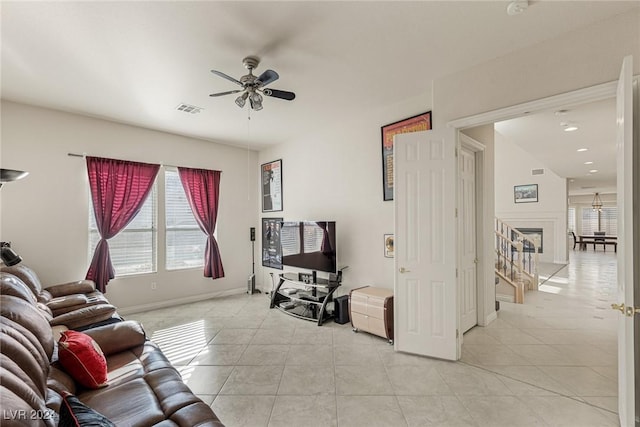 living room with ceiling fan and light tile patterned floors