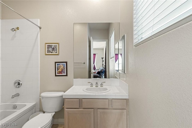 full bathroom featuring toilet, vanity, and tub / shower combination