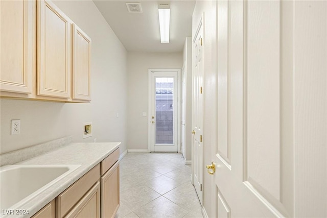 kitchen featuring light brown cabinets, light tile patterned floors, and sink