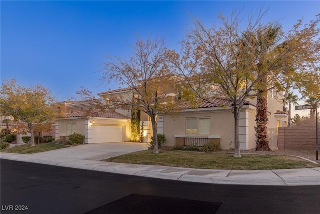 mediterranean / spanish-style home with a garage