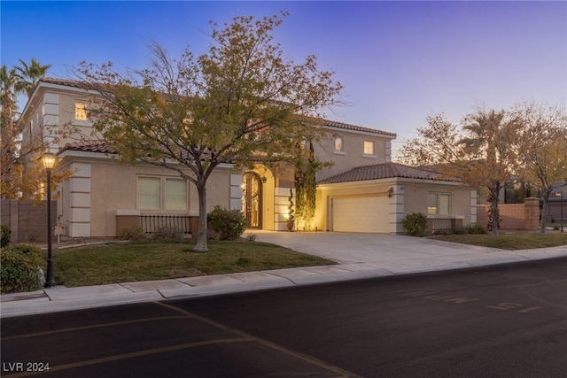 mediterranean / spanish house featuring a garage