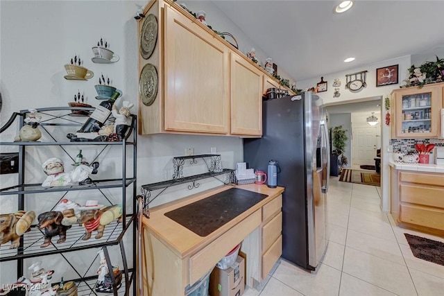 kitchen featuring tile counters, light brown cabinets, stainless steel fridge with ice dispenser, and light tile patterned floors