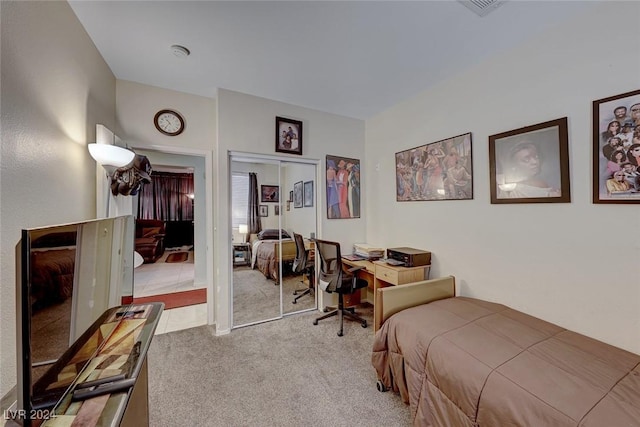 bedroom featuring light colored carpet and a closet