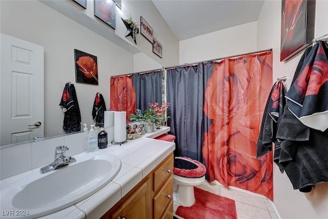 bathroom featuring toilet, vanity, tile patterned floors, and curtained shower