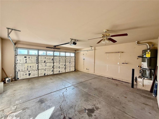 garage featuring secured water heater, a garage door opener, and ceiling fan