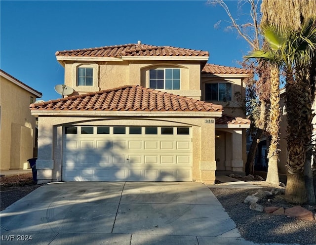 mediterranean / spanish house with a garage