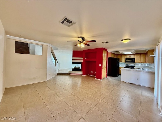 kitchen with decorative backsplash, ceiling fan, sink, black appliances, and light tile patterned floors