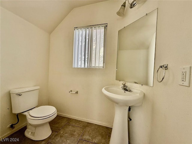 bathroom featuring tile patterned flooring, toilet, and lofted ceiling