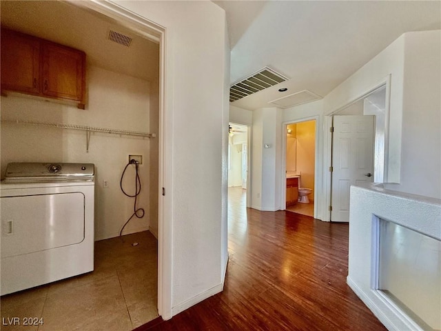 washroom with dark wood-type flooring and washer / clothes dryer