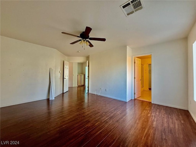 empty room with ceiling fan and dark hardwood / wood-style floors