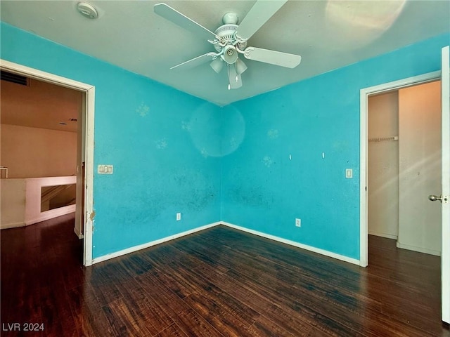 unfurnished room featuring ceiling fan and dark hardwood / wood-style flooring