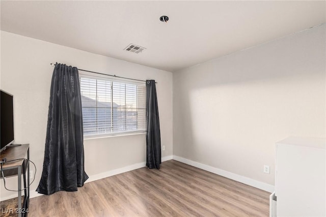 empty room with light hardwood / wood-style flooring