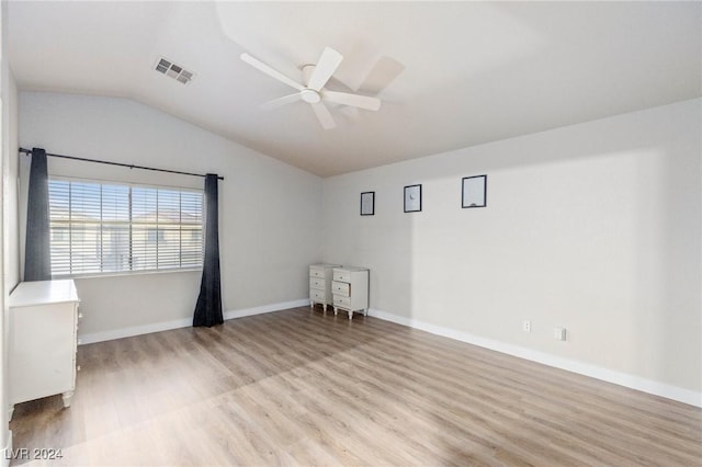 spare room featuring ceiling fan, light hardwood / wood-style flooring, and lofted ceiling