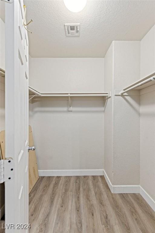 walk in closet featuring light wood-type flooring