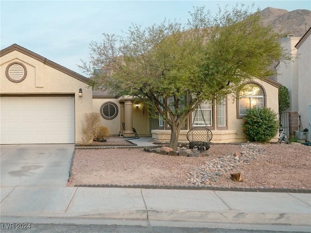 view of front of property with a mountain view and a garage