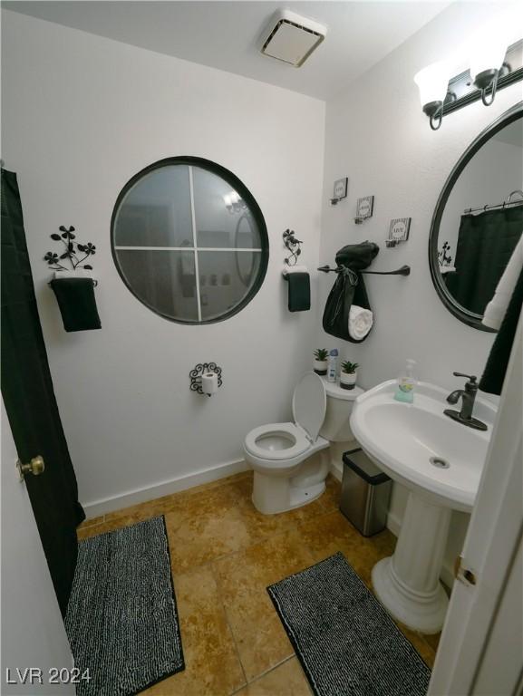 bathroom with tile patterned floors and toilet