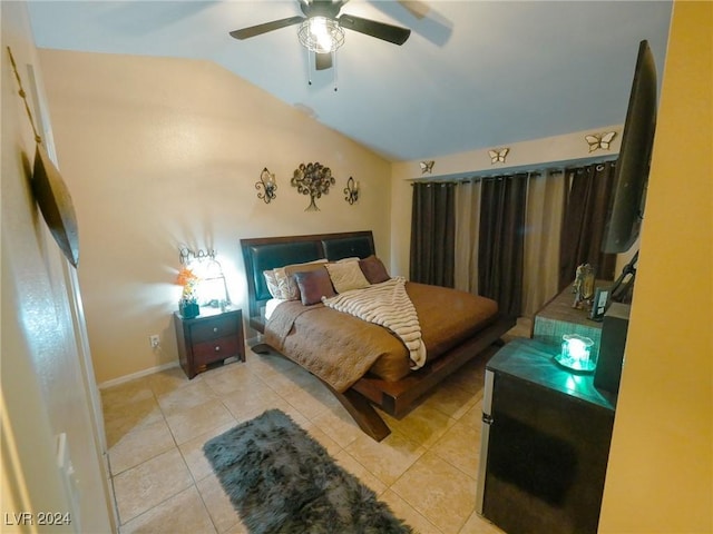 bedroom with ceiling fan, light tile patterned floors, and vaulted ceiling