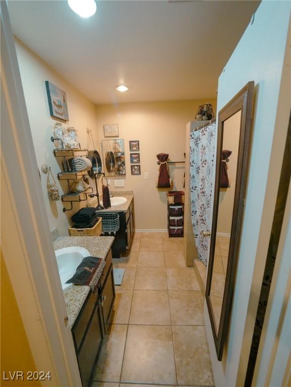 bathroom featuring tile patterned floors, vanity, and walk in shower