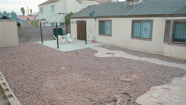 rear view of house with a gazebo and a patio