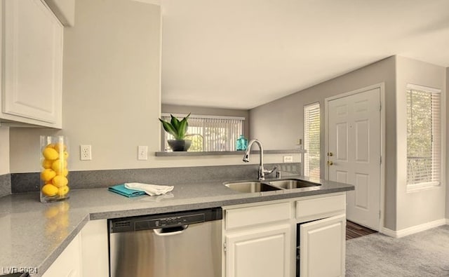 kitchen featuring sink, white cabinets, stainless steel dishwasher, kitchen peninsula, and carpet