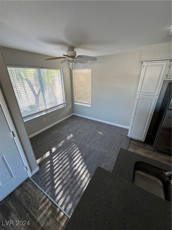 unfurnished living room with ceiling fan