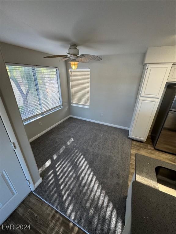 interior space with ceiling fan and dark wood-type flooring